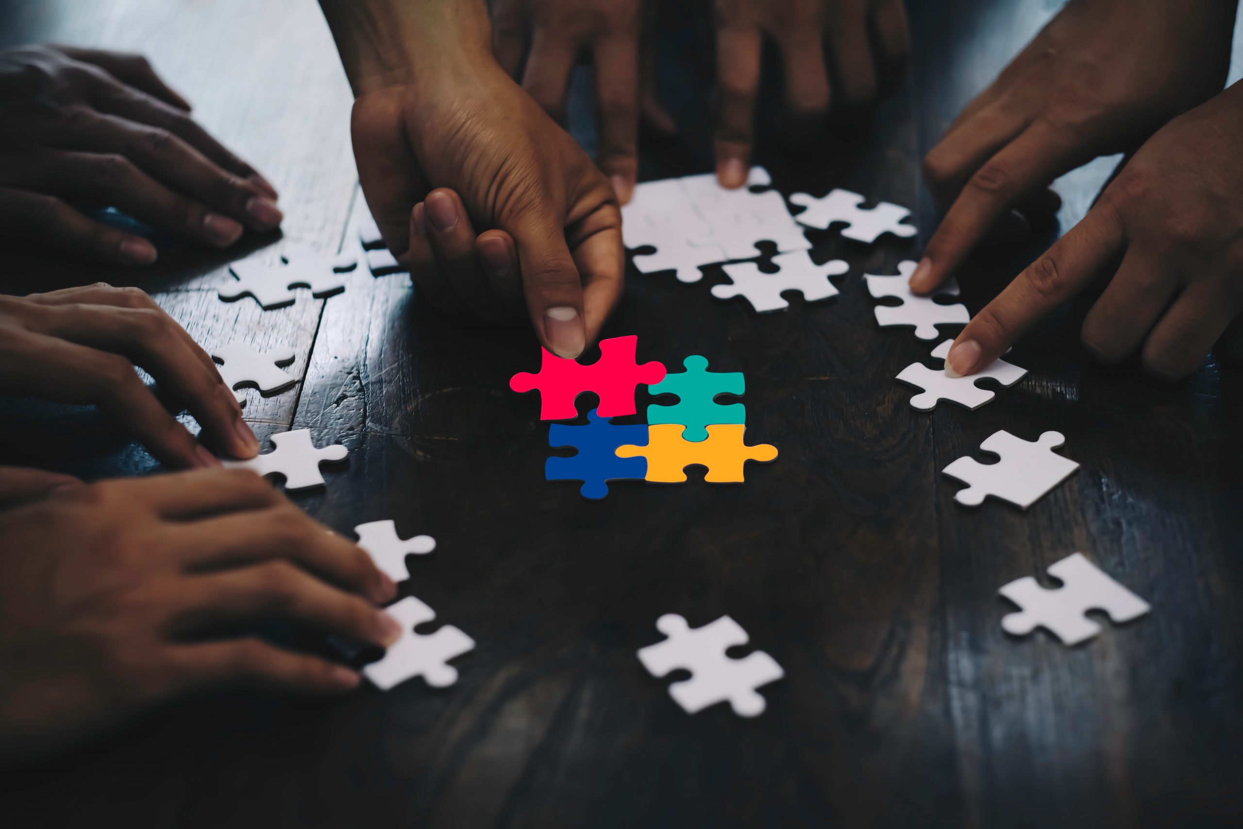 Closeup hand of business people connecting jigsaw puzzle with su